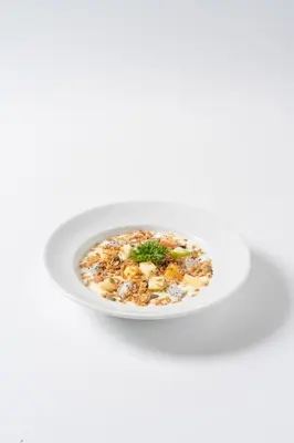 a white bowl of food on a white background at Sugar Ohana Poshtel in Kata Beach