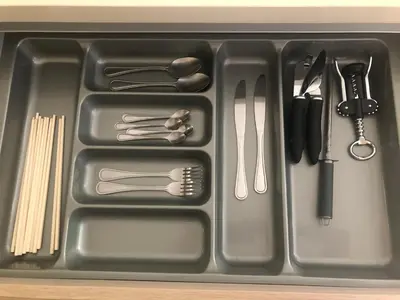 a plastic tray with utensils in a sink at Baan mai khao apartment in Mai Khao Beach
