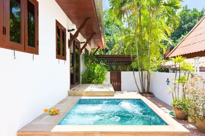 a swimming pool in the backyard of a house at Thai Style 2BR Villa Nikkie 2 in Nai Harn Beach