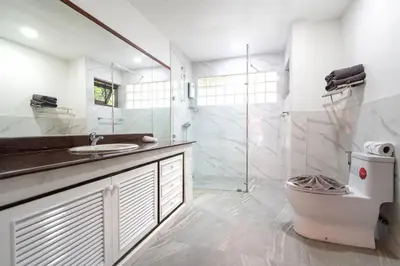 a bathroom with a sink and a shower and a toilet at Thai Style 2BR Villa Nikkie 2 in Nai Harn Beach