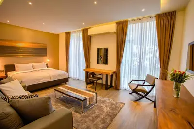 a hotel room with a bed and a living room at Ocean Rock Kalim in Patong Beach
