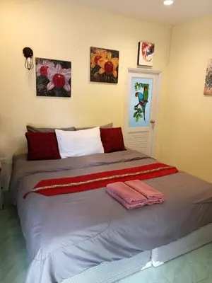 a bed in a room with two towels on it at Airee Mini House in Bang Tao Beach