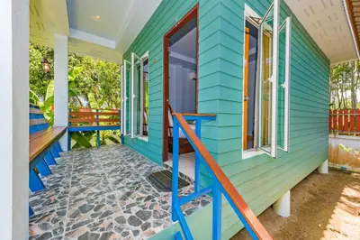 a colorful house with blue siding and windows at RAT VILLA in Ban Pa Khlok