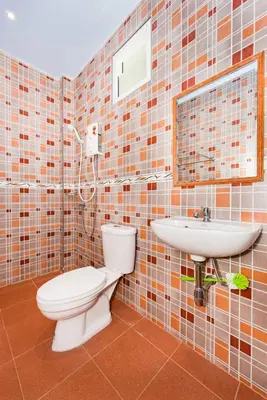 a bathroom with a toilet and a sink at RAT VILLA in Ban Pa Khlok