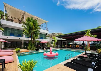 a swimming pool with a pink float in a hotel at CC's Hideaway Kata - SHA Plus in Kata Beach