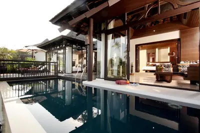a house with a swimming pool next to a house at The Vijitt Resort Phuket - SHA Extra Plus in Rawai Beach