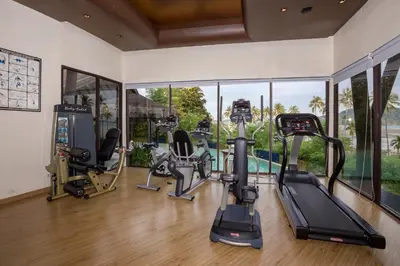 a gym with treadmills and elliptical machines at The Vijitt Resort Phuket - SHA Extra Plus in Rawai Beach