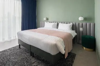 a bedroom with a large bed with white pillows at Our Nomad Boutique Hostel in Phuket Town