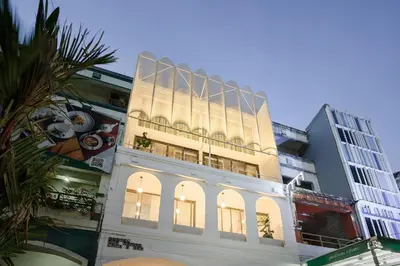 a tall building with a lit up facade at Our Nomad Boutique Hostel in Phuket Town