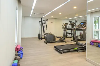 a gym with several exercise equipment in a room at Ramada by Wyndham Phuket Southsea in Karon Beach