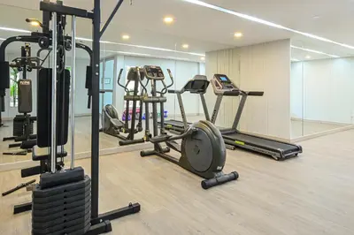 a gym with several treadmills and a treadmill at Ramada by Wyndham Phuket Southsea in Karon Beach