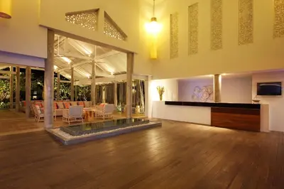 a large living room with a table and chairs at Ramada by Wyndham Phuket Southsea in Karon Beach