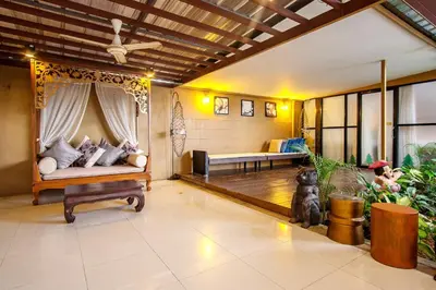 a living room with a couch and a table at Naiyang Beach Hotel SHA Plus in Nai Yang Beach