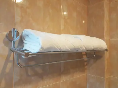 a towel rack in a shower with a pillow at Phi Phi Hotel in Phi Phi Don