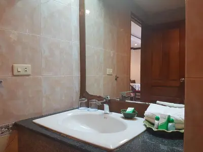a bathroom with a white sink and a mirror at Phi Phi Hotel in Phi Phi Don
