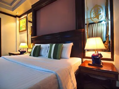 a hotel room with a large bed and a lamp at P.P. Casita - Adult Only in Phi Phi Don