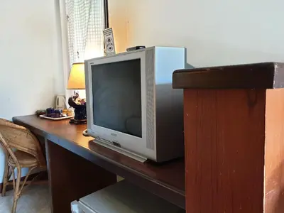 a television sitting on top of a wooden desk at P.P. Casita - Adult Only in Phi Phi Don