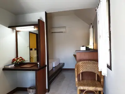 a room with a mirror and a table and a chair at P.P. Casita - Adult Only in Phi Phi Don