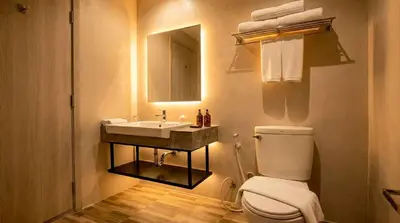 a bathroom with a toilet and a sink and a mirror at Beehive Boutique Hotel Phuket in Phuket Town