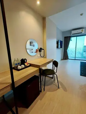 a room with a desk and a mirror on the wall at Beehive Boutique Hotel Phuket in Phuket Town