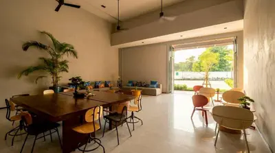 a dining room with a large wooden table and chairs at Beehive Boutique Hotel Phuket in Phuket Town