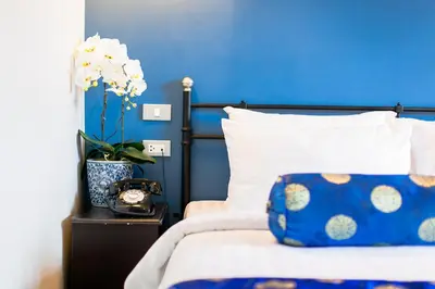 a blue bedroom with a bed with a blue wall at The Memory at On On Hotel in Phuket Town