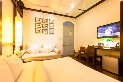 a living room with a couch and a dining room at The Memory at On On Hotel in Phuket Town