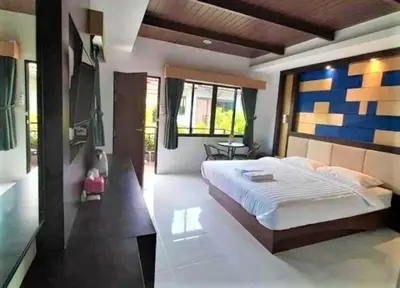 a bedroom with a large bed in a room at Thalang resort in Thalang