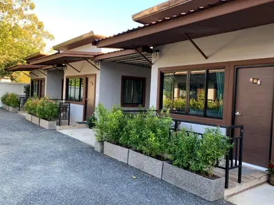 a house with a row of plants in front of it at Thalang resort in Thalang