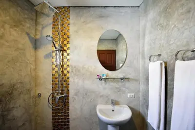 a bathroom with a sink and a mirror at At Kamala Hotel in Kamala Beach