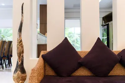 a living room with a couch with pillows at Villa Pimmada in Ao Nang Beach