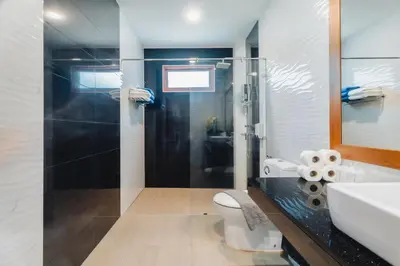 a bathroom with a shower and a toilet and a sink at Bangtao Boutique Villa in Bang Tao Beach