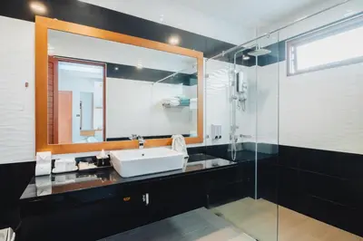 a bathroom with a sink and a mirror at Bangtao Boutique Villa in Bang Tao Beach