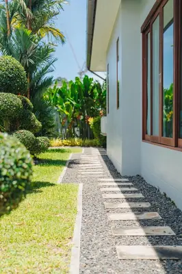 a stone walkway next to a building at Bangtao Boutique Villa in Bang Tao Beach