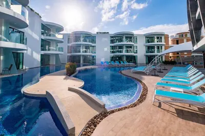 a large building with a swimming pool in front of it at Absolute Twin Sands Resort & Spa - SHA Extra Plus in Patong Beach