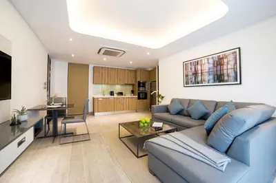 a living room with a couch and a table at Absolute Twin Sands Resort & Spa - SHA Extra Plus in Patong Beach