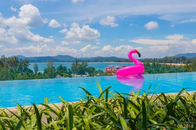 a pink swan in the middle of a swimming pool at The Aristo Beach by Holy Cow, studio, construction view in Surin Beach