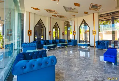 a lobby with blue chairs in a building at The Aristo Beach by Holy Cow, studio, construction view in Surin Beach