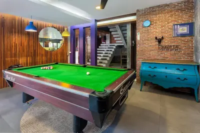 a room with a pool table and a staircase at Memory Boutique Patong in Patong Beach