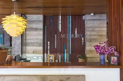a store window with a mercury sign and flowers at Memory Boutique Patong in Patong Beach