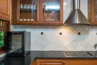a kitchen with a stove and a microwave at Pool villa at Nakatani Village by Lofty in Kamala Beach