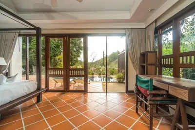 a bedroom with a bed and a desk at Pool villa at Nakatani Village by Lofty in Kamala Beach
