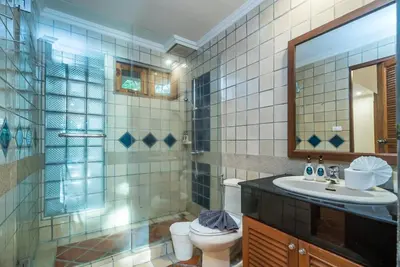 a bathroom with a sink and a toilet and a mirror at Pool villa at Nakatani Village by Lofty in Kamala Beach