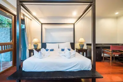 a bedroom with a bed with white sheets and pillows at Pool villa at Nakatani Village by Lofty in Kamala Beach