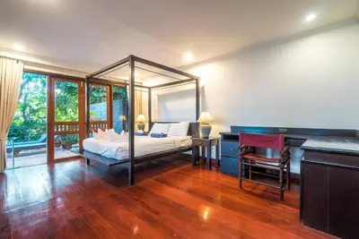 a bedroom with a bed and a desk and a piano at Pool villa at Nakatani Village by Lofty in Kamala Beach