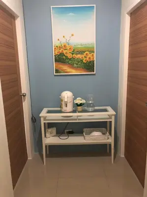 a room with a table with a picture on the wall at Khao Oat airport in Nai Yang Beach
