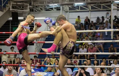 two men are fighting in a boxing match at 88 Hotel in Patong Beach