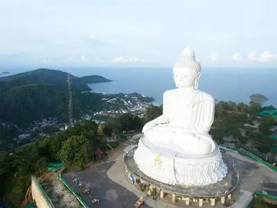 a large white statue sitting on top of a mountain at 88 Hotel in Patong Beach