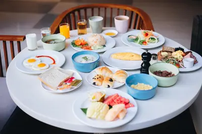 a white table with plates of breakfast food on it at Holiday Inn Express Phuket Patong Beach Central by IHG in Patong Beach