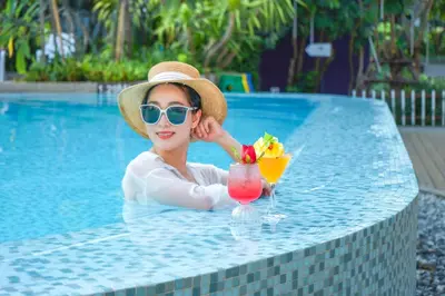 a woman sitting at a table with a drink at Holiday Inn Express Phuket Patong Beach Central by IHG in Patong Beach